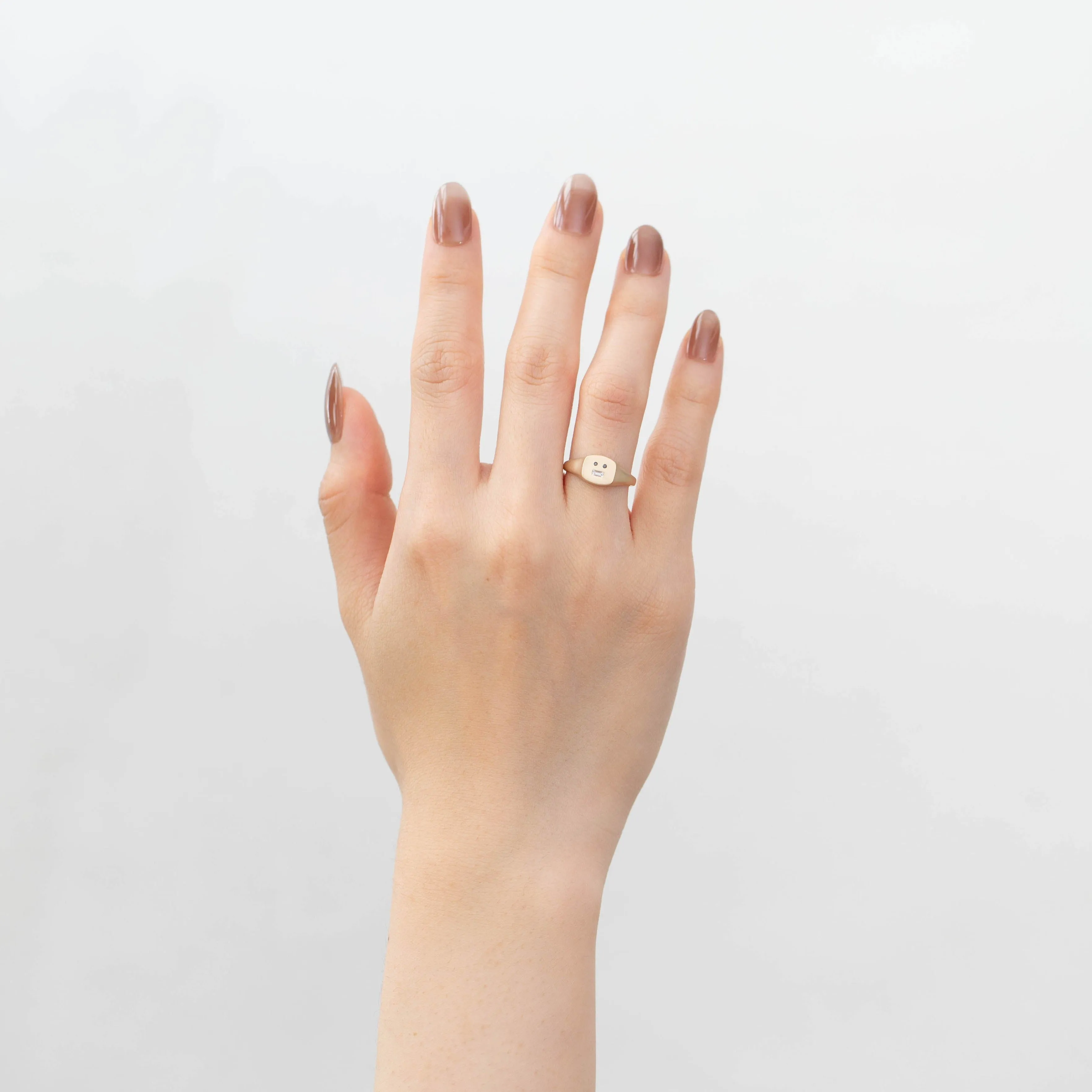 Small face signet ring with black and baguette diamond