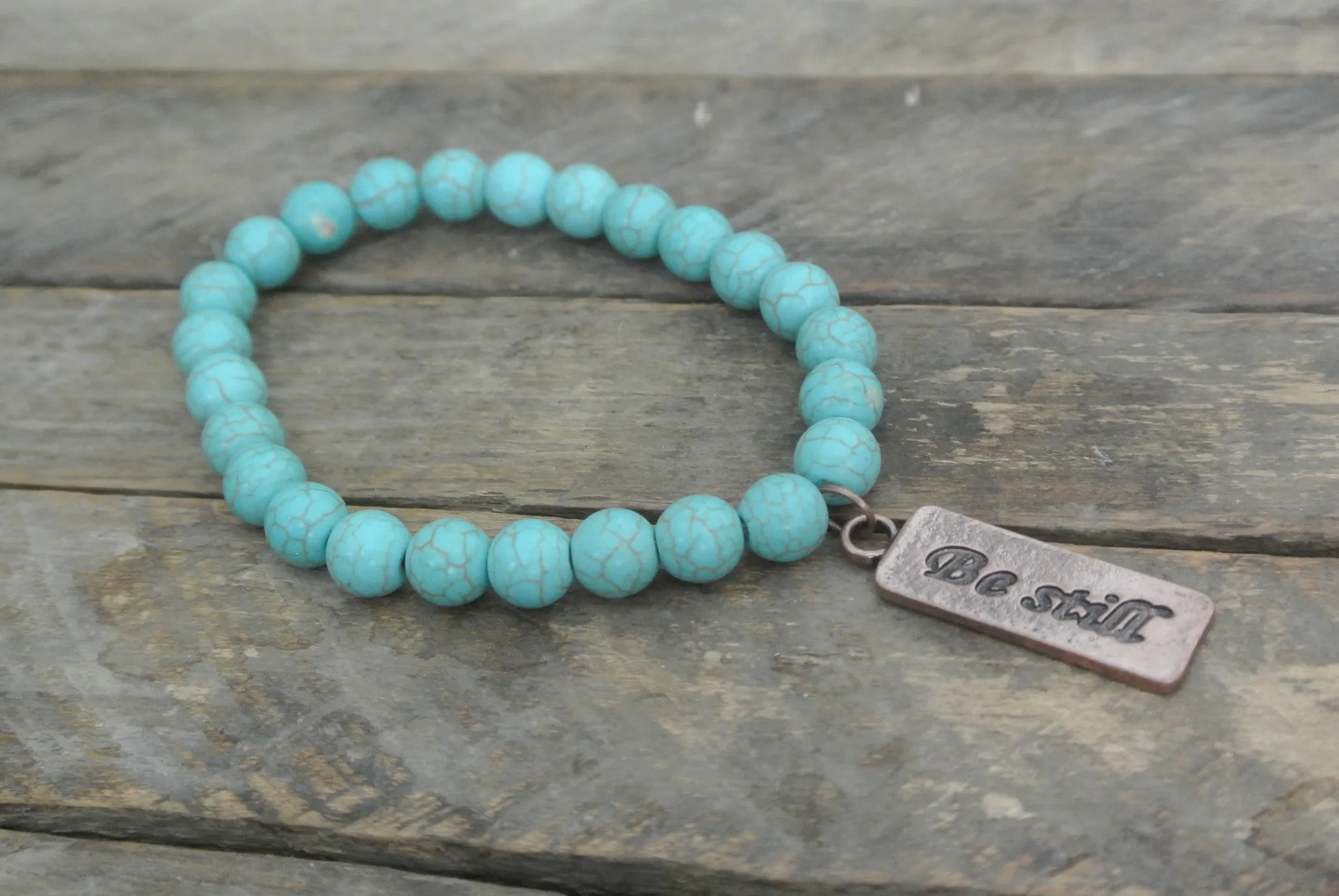 Turquoise beaded bracelet with Copper toned Be Still Charm